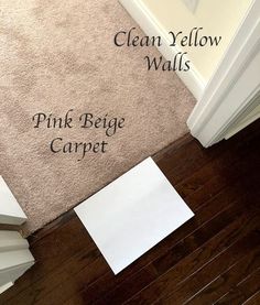 clean yellow walls with pink bejege carpet on the floor next to a white door