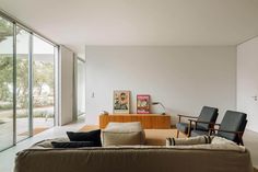 a living room filled with furniture and lots of windows