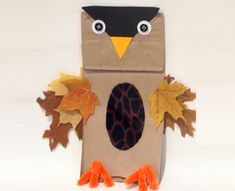 a paper bag with an owl and leaves on it