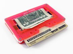 a pink cassette with money in it