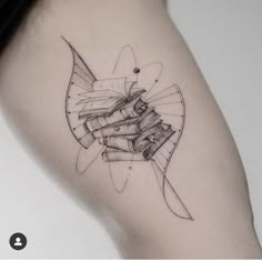 a black and white photo of a tattoo with books on it