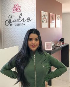 a woman standing in front of a sign that says studio by cressica