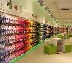 there are many pairs of shoes on display in the shoe store's colorful displays