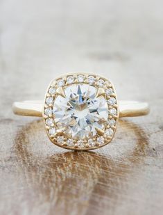 The Harlow is exquisite. She exhibits a forceful brilliance, but remains delicate and feminine at the same time. Her center stone is a source of light and love, while the diamond accents on the halo add an even more unbelievable sparkle to the design. Approx Band Width (mm): 1.70mm Setting Diamond Quality (side stones): Colorless and VS clarity Approx Setting Total Carat Weight (side stones): 0.099 tcw Approx Production Time: 5-6 weeks Drop-down diamond options represent our recommended grade, w Circle Engagement Ring, Circle Engagement Rings, Unique Engagement Rings Halo, Cushion Halo Engagement Ring, Pave Band, Plain Bands, Yellow Gold Setting, Green Sapphire, Halo Diamond Engagement Ring