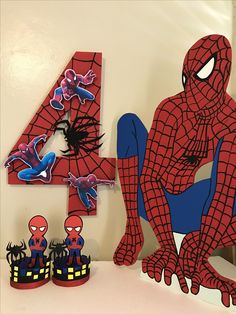 a number four with spiderman decorations and shoes on the floor in front of it