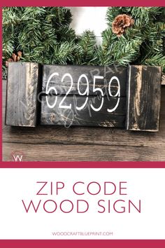 a wooden sign with the words zip code wood sign on it and pine cones in front