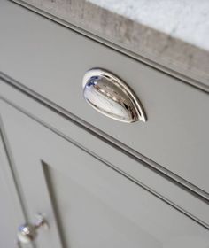 a close up of a drawer handle on a cabinet