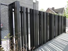 a black metal fence next to a building