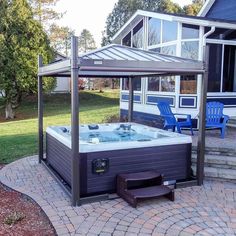 a hot tub sitting on top of a brick patio