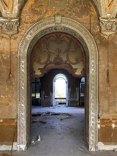 an old building that has been painted gold and is being renovated with paint peeling off the walls