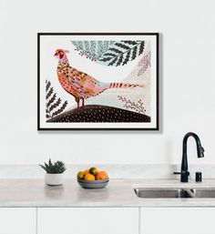 a painting hanging on the wall next to a bowl of fruit and a sink with a faucet