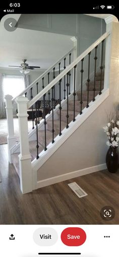 a living room with hardwood floors and white railings