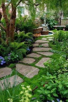 a stone path in the middle of a garden