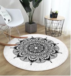 a black and white circular rug with an intricate flower design on the floor next to a rocking chair