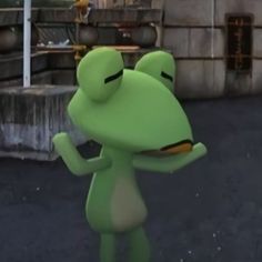 a green frog is standing in front of a building