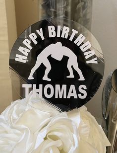 there is a birthday cake that has a giant man on it and the words happy birthday thomas