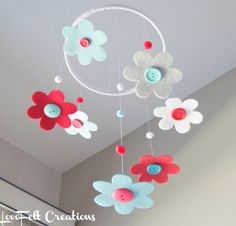 a mobile with flowers hanging from the ceiling