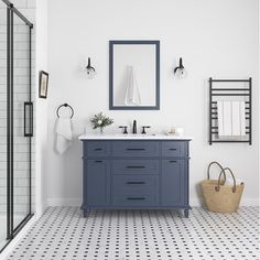 a white and blue bathroom with two mirrors on the wall next to a black and white tiled floor