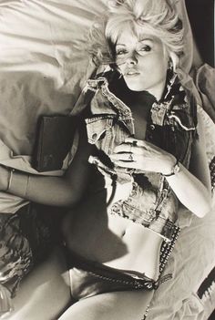 a black and white photo of a woman laying in bed