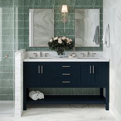 a bathroom with two sinks and a large mirror in it's center, next to a walk - in shower