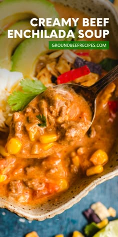 creamy beef enchilada soup with corn and avocado on the side