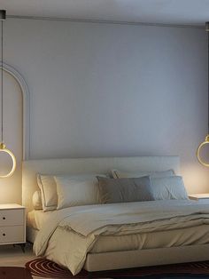 a white bed sitting in a bedroom next to two lamps on either side of it