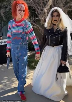 two people in costumes walking down the street