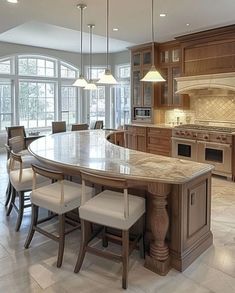 a large kitchen with an island in the middle and lots of counter space around it