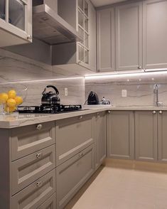 an instagram photo of a kitchen with grey cabinets and white counter tops, along with yellow balloons