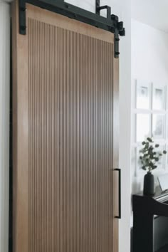 a room with a wooden door and black table