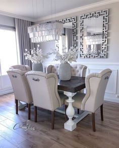 the dining room table is set with beige chairs