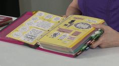 a woman is holding a binder with notes on it