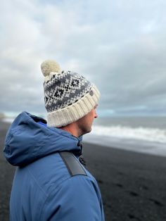 "Elevate your winter wardrobe with our men's woolen bobble hat, exquisitely designed for warmth, comfort, and style. Crafted from high-quality pure wool, this winter cap not only keeps you toasty but also adds a touch of Scandinavian charm to your look. Key Features: 1. Premium Wool Comfort: Made from pure wool, our winter cap offers superior insulation to keep you warm in the chilliest of weather. The natural breathability of wool ensures your head stays comfortably cozy. 2. One-Size-Fits-Most: Warm Nordic Beanie For Outdoor, Nordic Knitted Hat For Cold Weather, Nordic Style Winter Hat For Outdoor Activities, Nordic Knitted Beanie For Winter, Nordic Knitted Winter Beanie, Fair Isle Beanie Hats For Winter, Winter Fair Isle Pattern Beanie Hat, Winter Fair Isle Beanie Hats, Nordic Knitted Winter Hat