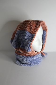 a crocheted hat and scarf on a mannequin's head