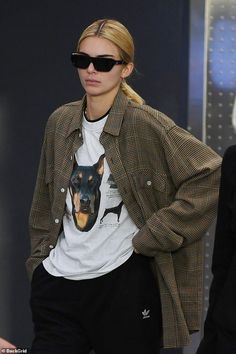 a woman wearing sunglasses and a t - shirt with a dog on it