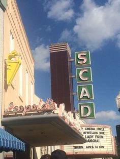 people are standing in front of a theater