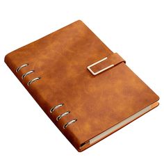 a brown leather notebook with a metal clip on the front and bottom cover is open