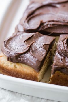 a cake with chocolate frosting sitting on top of a white plate