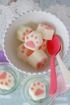 two small bowls filled with pink and white treats