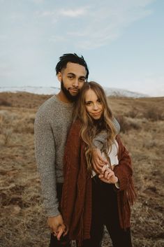 a man and woman standing together in the desert