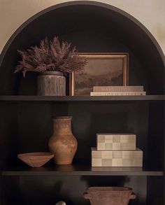 a shelf with vases and other items on it