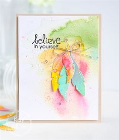 a handmade card with watercolored leaves and the words believe in yourself