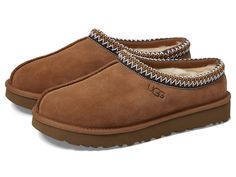 UGG Tasman - Women's Shoes : Chestnut : The Tasman always fits tight at first especially if someone has a high instep or high volume foot. It does stretch out over time. If you are in between sizes, please size up or down based on the volume of your foot and height of your instep. Take the suede UGG Tasman slip-on from weekday lounging to a Saturday excursion! Features a Tasman trim and a raw seam down the center with an embossed UGG logo at lateral side. Luxurious sheepskin lining for breathability and warmth and a generous UGGpure wool cushioned footbed offers lasting comfort. Durable polyester binding. Treadlite by UGG outsole provides increased traction, durability, cushioning, and flexibility. Imported. Real sheep fur or lamb has been artificially dyed and treated. Fur origin: Austral Taxman’s Uggs, Uggs Tasman, Chestnut Uggs, Ugg Tasman Slippers, Ugg Tasman, Wool Cushion, Kids Uggs, Swag Shoes, Comfy Shoes