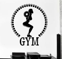 a wall decal with the word gym in black and white, on a table