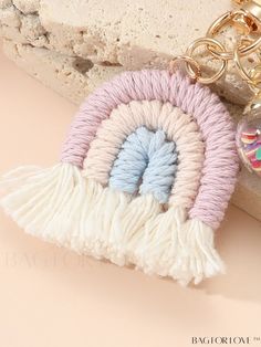 a keychain with a pink, white and blue eyeball charm hanging from it's side