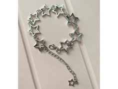 Our Y2K Star Charm Bracelet captures the playful spirit of the late '90s and early '00s with its chic star motifs and sleek metal craftsmanship. Perfect for anyone who loves adding a hint of sparkle and nostalgia to their look. Key Features Chic Star Charms: Each charm is shaped like a star, offering a whimsical yet elegant appeal that shines in any light. High-Quality Metal: Crafted from durable metal for a long-lasting finish that resists wear and tarnish. Adjustable Fit: Comes with an adjusta Star Charm Bracelet, Bracelet Star, Y2k Star, Jewelry Elegant, Link Chain Bracelet, Bracelet Women, Late 90s, Elegant Gifts, Star Jewelry