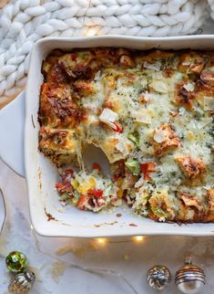 a casserole dish with broccoli, cheese and other vegetables in it