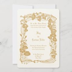 a wedding card with gold flowers and leaves on the front, in an ornate frame