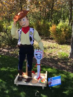 a scarecrow standing on top of a piece of wood