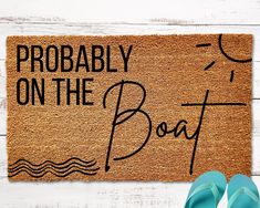 a door mat that says, probably on the boat with flip flops next to it